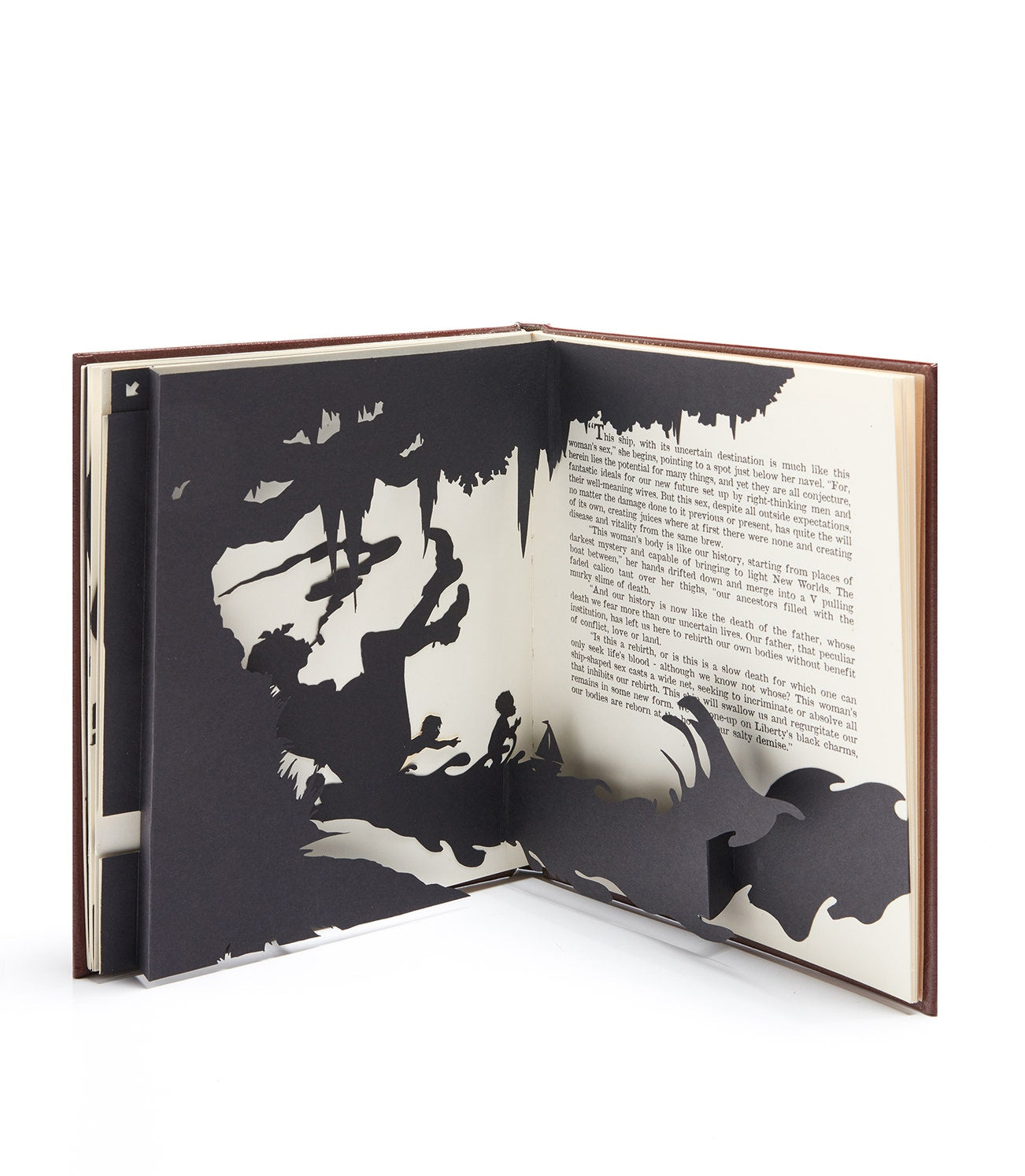 Open pages with black-and-white 3D pop-up paper sculpture art and text by Kara Walker.