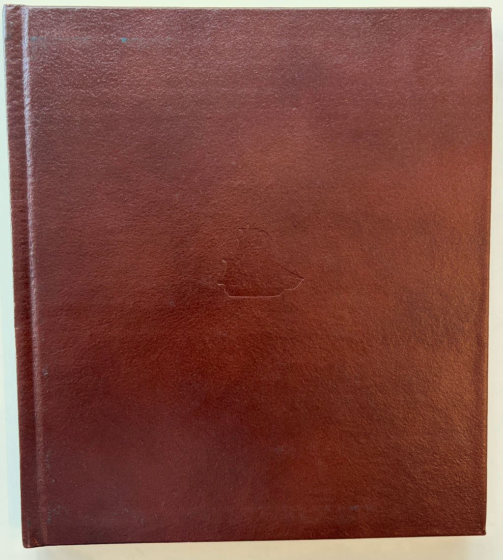 Leather front cover with debossed art.